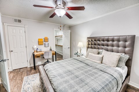 a bedroom with a bed and a ceiling fan